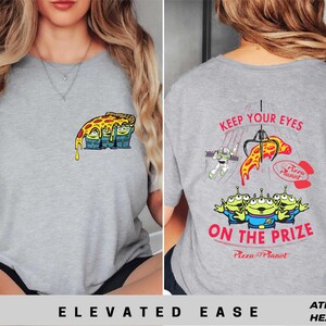 a woman wearing a grey shirt with a cartoon character on it