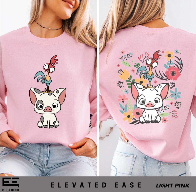 a woman wearing a pink sweatshirt with a cartoon cat on it