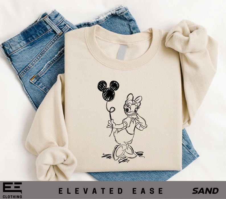 a t - shirt with a drawing of a rabbit holding a balloon