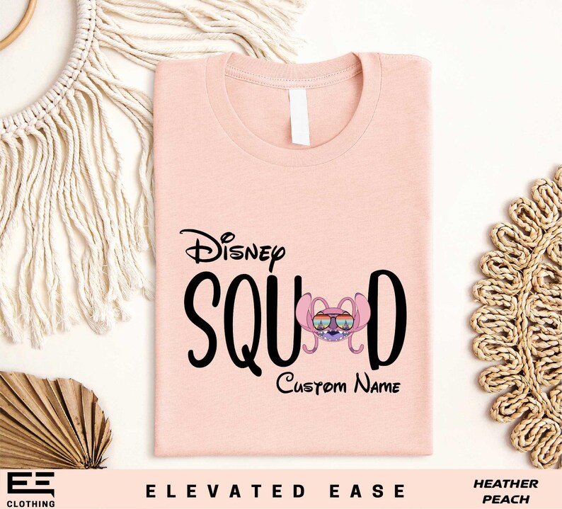a pink tshirt with the disney squad name on it