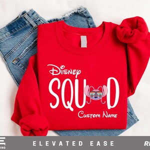 a red shirt with the name of a character on it and a pair of jeans