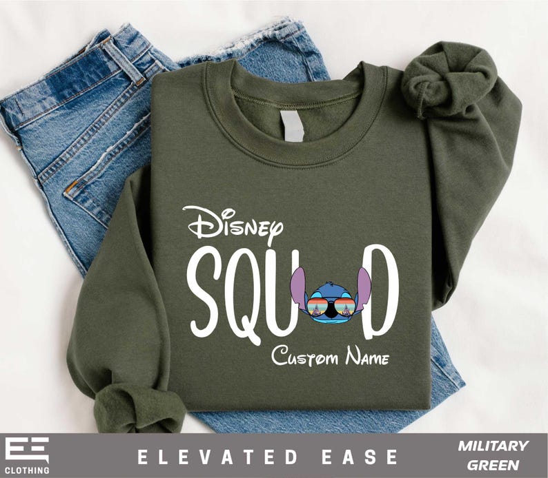 a green sweatshirt with a pair of jeans next to it