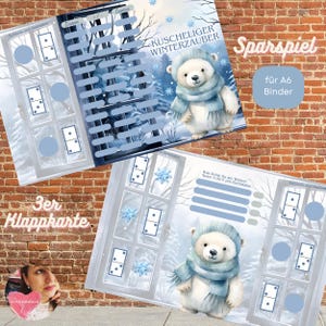 May include: Two winter-themed cards featuring a polar bear illustration in a blue hat and scarf. The cards have a window design with dominoes and snowflakes. Text includes "Kuscheliger Winterzauber" and "Sparspiel für A6 Binder".