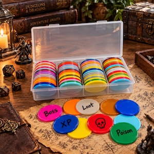 May include: A clear plastic storage container filled with stacks of colourful circular tokens. Several loose tokens are arranged in front, featuring black printed text and symbols including Boss, Loot, XP, Poison, and a skull icon on various coloured discs.