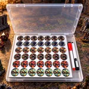 May include: A clear plastic storage case containing a grid of circular tokens with various fantasy character illustrations and numbers. The set includes a white dry-erase marker with a red cap and a black eraser tip, all arranged on a white backing.