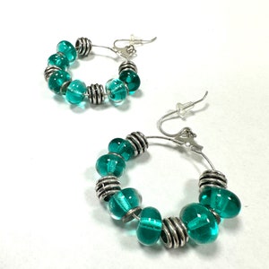 Gorgeous, eye-catching transparent turquoise green glass beaded hoop earrings.