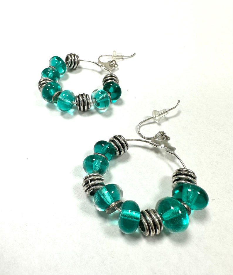 Gorgeous, eye-catching transparent turquoise green glass beaded hoop earrings.