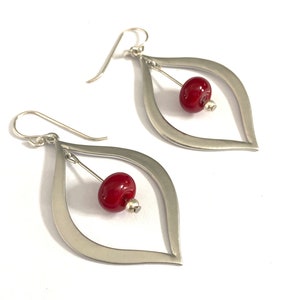 Stunning silver teardrop earrings with gorgeous red lampwork bead earrings floating in the center. These beads are made by hand using a torch and kiln.