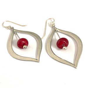 Dressy and modern red beaded earrings with silver teardrops.