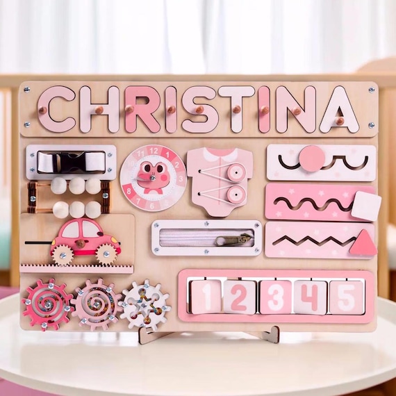 A handcrafted wooden Montessori busy board with a custom name puzzle — 412 favorites is a thundering signal that real parents are buying this, and the multi-sensory, educational craft execution is genuinely impressive.
