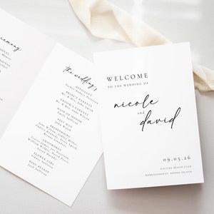 May include: A white wedding welcome sign with black text. The text reads "Welcome to the wedding of Nicole and David" with the date "09.05.26" and the location "Galilee Beach Club, Narragansett, Rhode Island".