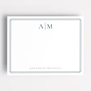 May include: White stationery with a double navy blue border. The stationery features the initials "A M" in navy blue at the top and the name "ANNABELLE MICHAELS" at the bottom, centered.