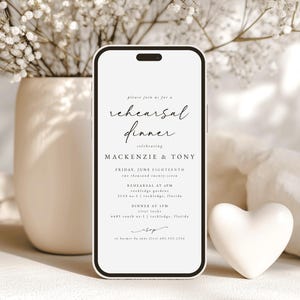 May include: A white smartphone mockup with a black border displays a wedding rehearsal dinner invitation for Mackenzie & Tony. The invitation features a script font and includes the date, time, and location for both the rehearsal and dinner.