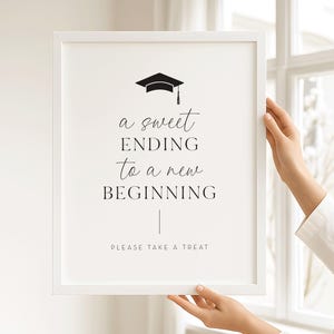 Pode incluir: Uma placa de formatura com moldura branca com o texto "a sweet ending to a new beginning" e um gráfico de chapéu de formatura. A placa também inclui o texto "please take a treat".