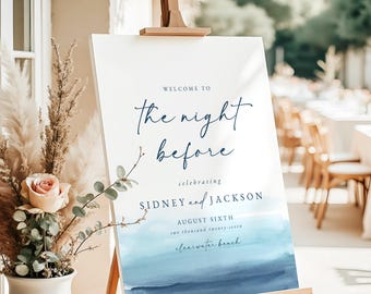 May include: Welcome to the night before sign with a watercolor background in shades of blue. The sign is on an easel and says "Welcome to the night before celebrating Sidney and Jackson August Sixth two thousand twenty-seven Clearwater Beach."