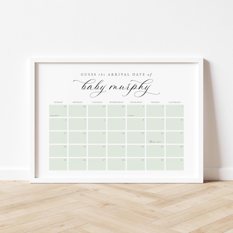May include: A framed calendar print with the text "Guess the arrival date of baby murphy" in elegant script. The calendar grid features pale green squares and dates for September and October. The frame is white.