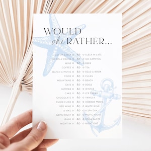 May include: A white card with the text "WOULD she RATHER..." in black. The card has light blue starfish and anchor illustrations. The text lists various choices, such as "Get up early" or "Sleep in late."