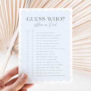 May include: A baby shower game card with a light blue scalloped border. The card reads "GUESS WHO? Mom or Dad" and includes a list of questions to determine who will be the fun parent, change more diapers, and more.