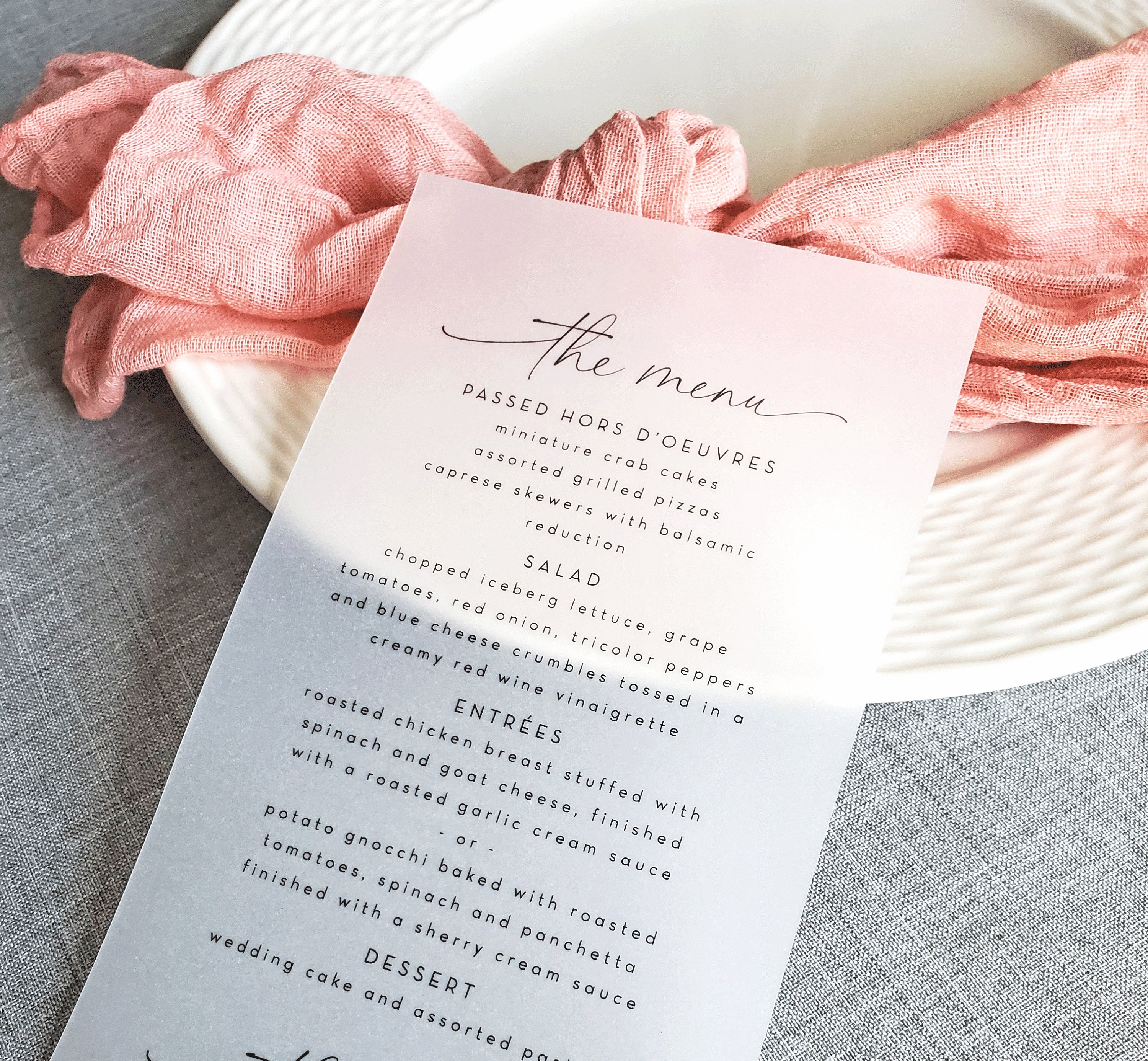 A menu card in off-white shades with a punched-out church and vellum paper
