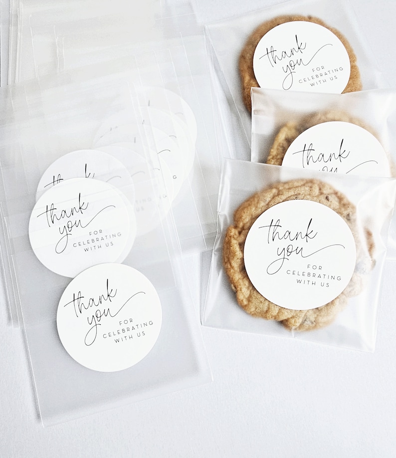 May include: Clear cellophane bags filled with cookies and round white stickers that say "Thank you for celebrating with us".