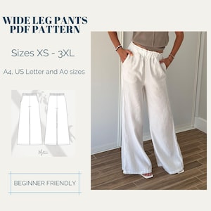 Op de afbeelding: Witte broek met wijde pijpen en een elastische tailleband. De afbeelding bevat ook een patroon voor een broek met wijde pijpen, met de tekst "WIDE LEG PANTS PDF PATTERN" en "Maten XS - 3XL". De tekst "BEGINNER FRIENDLY" is ook zichtbaar.