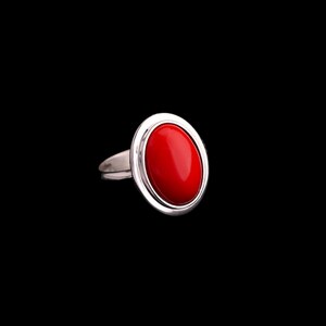 May include: A silver ring with a bright red oval gemstone.