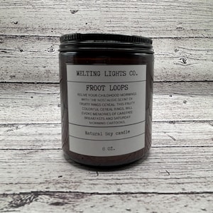 May include: A brown glass jar candle with a white label that reads "Melting Lights Co. Froot Loops". The label describes the candle as a natural soy candle with a scent inspired by the fruity cereal. The jar is 8 oz.