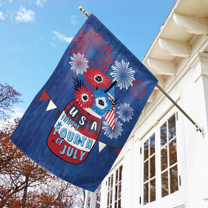May include: A blue and red flag with a mason jar filled with red, white, and blue flowers and fireworks. The text on the flag reads "USA Happy Fourth of July".