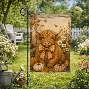 May include: A rectangular garden flag featuring a fluffy brown Highland cow with long horns and a plaid bow around its neck. The cow is surrounded by orange pumpkins, white pumpkins, and white daisies against a rustic wooden fence background.
