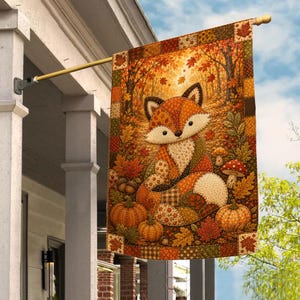 May include: A rectangular garden flag featuring a patchwork-style illustration of a fox sitting among autumn leaves, pumpkins, and mushrooms. The design uses warm orange, brown, and gold tones with a decorative border of small fabric-like squares.
