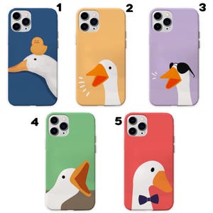 May include: Five different iPhone cases with a goose design. The cases are in various colors, including blue, yellow, purple, green, and red. Each case features a different goose design, including a goose with a duckling, a goose with sunglasses, and a goose with a bow tie.