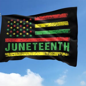 May include: A black flag with red, yellow, and green stripes and a field of stars. The flag has the word "Juneteenth" written in green letters on the bottom.