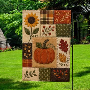 May include: A rectangular garden flag featuring a patchwork design with a central orange pumpkin, a large yellow sunflower, and various autumn-themed patterns including plaid, polka dots, and foliage in shades of brown, green, and orange.
