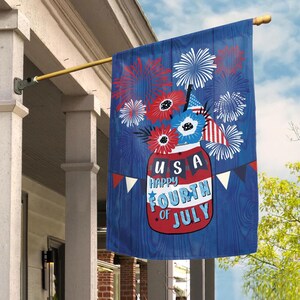 May include: A blue and red Fourth of July themed flag with a mason jar filled with red, white, and blue flowers and fireworks. The jar has the text "USA Happy Fourth of July" on it.