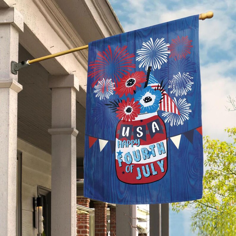 May include: A blue and red Fourth of July themed flag with a mason jar filled with red, white, and blue flowers and fireworks. The jar has the text "USA Happy Fourth of July" on it.