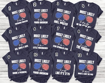 May include: Twelve navy blue t-shirts with white text and graphics. Each shirt features a pair of sunglasses with an American flag design and a different humorous phrase related to the 4th of July. The phrases include "Most Likely to be the Fireworks Director", "Most Likely to be a Proud American", "Most Likely to be the Grill Master", "Most Likely to Stay Fly on the 4th of July", "Most Likely to be Red, White & Cute", "Most Likely to be a Little Firecracker", "Most Likely to be a Star Spangled Stud", "Most Likely to Watch the Parade", "Most Likely to be Drunk & Patriotic", "Most Likely to be a Proud American", "Most Likely to Party Like It's 1776", and "Most Likely to Drink Booze & Light the Fuse".