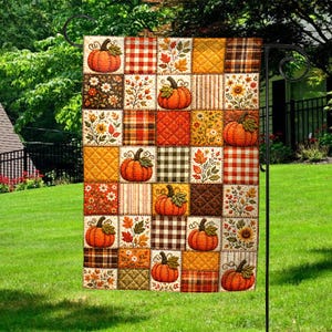 May include: A rectangular garden flag featuring a patchwork design of autumn-themed squares. The pattern includes orange pumpkins, brown and orange plaid, red and white gingham, and various fall foliage motifs in shades of yellow and brown.
