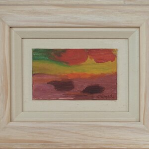May include: A framed abstract painting with a red, yellow, green, and purple colour scheme. The painting is signed "C. Caprile" in the bottom right corner.