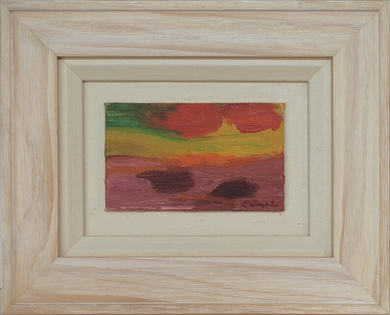 May include: A framed abstract painting with a red, yellow, green, and purple colour scheme. The painting is signed "C. Caprile" in the bottom right corner.