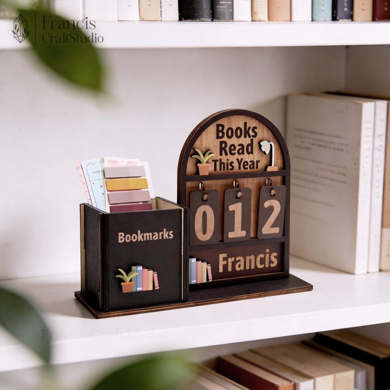 May include: A wooden desk organizer with a bookmark holder and a "Books Read This Year" counter. The organizer is dark brown with light brown numbers and text. The bookmark holder is filled with colorful sticky notes. The text "Francis" is at the bottom.