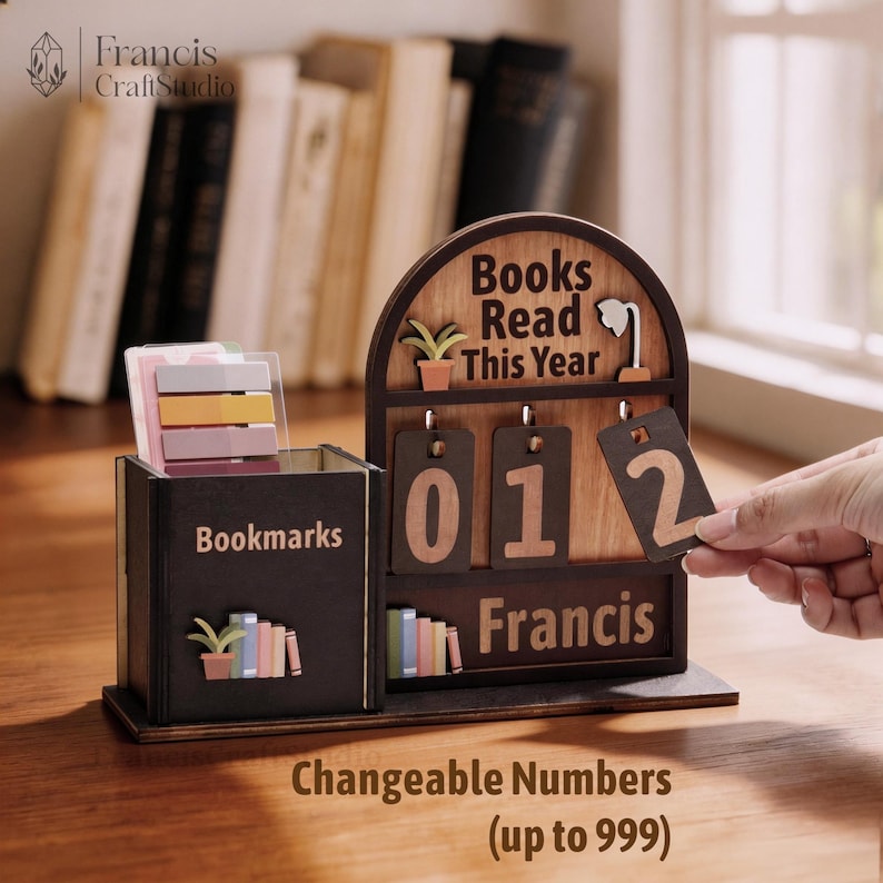 May include: A wooden desk organizer with a bookmark holder and a "Books Read This Year" counter. The counter displays "012" with changeable numbers up to 999. The organizer has the name "Francis" on it.