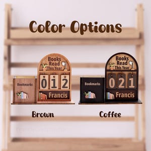 May include: Wooden desk organizers in brown and coffee colors. Each features a "Books Read This Year" counter, a "Bookmarks" holder, and a nameplate. The brown organizer shows "012" books read, while the coffee one shows "021".