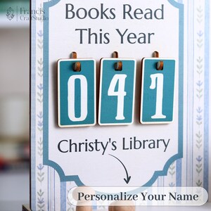 May include: A wooden sign with the text "Books Read This Year" and the number "041" displayed on teal rectangles. The sign also includes the text "Christy's Library" and "Personalize Your Name".