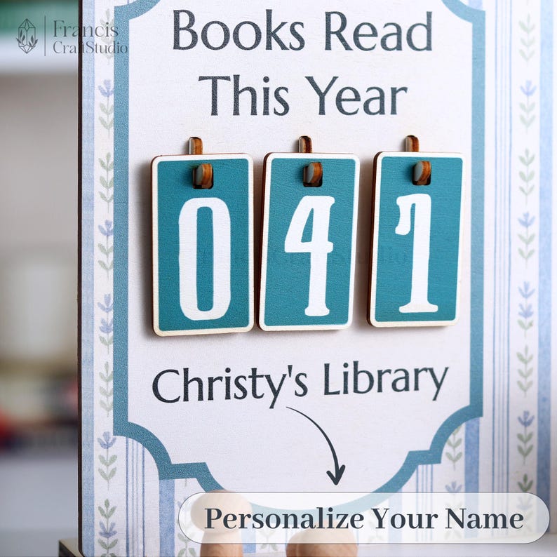 May include: A wooden sign with the text "Books Read This Year" and the number "041" displayed on teal rectangles. The sign also includes the text "Christy's Library" and "Personalize Your Name".