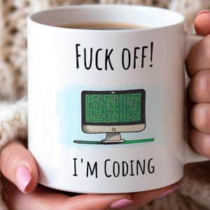 May include: White ceramic mug with the text "FUCK OFF! I'M CODING" in black. The mug features a cartoon computer screen displaying green code. A humorous gift for programmers and tech enthusiasts.