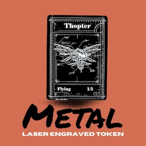 May include: Black and white laser-engraved metal token with a detailed illustration of a flying machine labeled "Thopter." The token has the word "Flying" and "1/1" printed on it. The word "METAL" is printed in large, bold letters below the token.