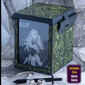 May include: A black and olive green deck box featuring an engraved floral pattern and a front display window showing an elf character card with the text ELF. The box includes a black sword-shaped object and two metallic dice in the foreground.