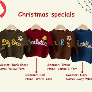 May include: Four children's sweaters in dark green, red, brown, and navy blue, each with a name embroidered in a contrasting color. The sweaters are displayed on wooden hangers, with the text "Christmas specials" above them.
