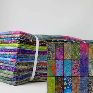 May include: A collection of batik fabric bundles, secured with a white ribbon. The fabrics feature diverse patterns and colours, including blues, greens, purples, and pinks. A smaller grid displays individual fabric designs.