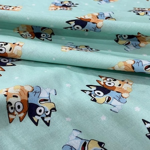 Bluey & Bingo Fabric – Aqua Cartoon Dogs – Quilting Cotton by the Yard